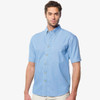 A short sleeve cotton denim shirt in light blue, featuring a button-up front and a single chest pocket.