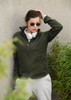 A green women's jacket with a zip front and pockets, worn over a grey hoodie, paired with sunglasses and headphones.