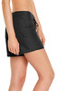 Women's black cargo board shorts with a drawstring and side pockets, featuring a logo on the fabric.