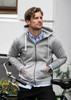 A grey hoodie with a zipped front and drawstrings, worn by a man sitting beside a bicycle.
