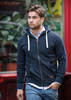 A navy hooded jacket with a zip and front pockets, featuring a logo, worn by a man walking outdoors.