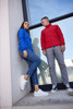 A blue and a red ladies' bonded fleece jacket displayed on models, with casual attire and footwear.