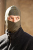 A green balaclava worn by a person, featuring a fitted design and a partial face cover.