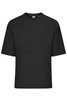 An oversized black T-shirt with short sleeves and a round neckline, featuring a logo on the tag.