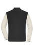 A varsity jacket featuring a black body with cream-coloured sleeves, complete with a ribbed collar and cuffs.
