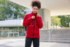 A red fleece jacket with a corduroy look, featuring a zippered front and a stylish collar. It has a logo.