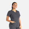 A grey women's curved V-neck top featuring short sleeves and a side pocket, with a logo on the chest.