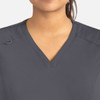 A women's curved V-neck top in grey with a subtle logo on the shoulder.