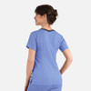 A women's double V-neck top in blue with a contrasting back and short sleeves. The top features a logo.