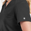 A women's tuckable V-neck top in black with a small logo on the sleeve and a front pocket.
