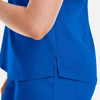 A close-up of a vibrant blue women's V-neck top featuring a tuckable design and side slit. The top has a branding logo.