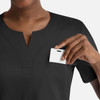 A black women's notched crew neck top with a pocket, featuring a hand placing an item inside.