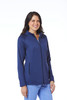 A woman wearing a navy fleece jacket with a zip front and side pockets, featuring a logo.