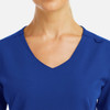 A close-up of a women's v-neck top in vibrant blue with metallic detail and a smooth neckline.