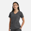 A women's grey V-neck top featuring metallic detail and two front pockets, designed with a structured fit.