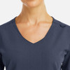 A v-neck top in dark navy with metallic detail and a subtle logo feature.