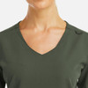 A women's v-neck top in olive green with a metallic detail and a simple neckline design.