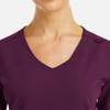 A v-neck top in a rich purple colour, featuring metallic detail and a sleek design.