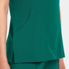 A women's v-neck top in a rich green colour, featuring a side pocket and a sleek design.