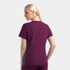 A mock wrap top in plum with grey contrast panels, featuring a logo. Designed for women, back view shown.