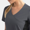 A mock wrap top in dark grey, featuring contrast panels on the sides and a V-neck design. It has a logo.
