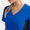 A blue mock wrap top features contrast black panels on the sides, designed for women.