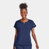 A women's navy blue notched neck dolman top featuring short sleeves and a front pocket. It includes a branding logo.
