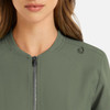 A green women's bomber jacket featuring a full zip and a logo on the shoulder.