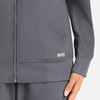 A women's full zip bomber jacket in grey, featuring a textured finish and a small logo on the hem.