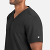 A black men's tuckable henley top featuring short sleeves and a buttoned neckline, with a logo on the sleeve.