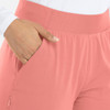A close-up of a mid-rise elastic jogger in light pink, featuring a pocket and textured waistband.
