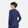 A woman in a navy round neck snap jacket, viewed from the back, showcasing its simple design.