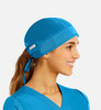 A unisex scrub cap in bright blue fabric, featuring a logo, designed for medical uniforms.