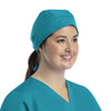 A unisex scrub cap in teal with buttons, designed for comfort and functionality.