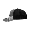 A grey camo trucker hat with a structured mid-profile design and a black mesh back. Features a logo.