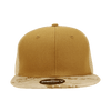 A high profile structured trucker cap in tan with a camo patterned brim. It features a logo on the front.