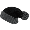 A black and grey beanie with a chunky knit pattern and a pom-pom on top, featuring a logo.