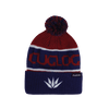 A beanie in red and blue with a pom-pom on top and a logo on the side.