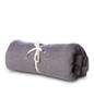 A rolled grey blanket tied with cream ties, featuring a simple, soft, and textured fabric.