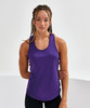 A purple performance strap back vest on a model with braided hair, posing against a neutral background.