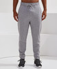 Fitted joggers in light grey, featuring an elastic waistband and a casual fit. The model wears dark footwear.