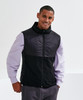 A black and purple insulated hybrid gilet, featuring a zip front and a stand collar, with a branded logo.