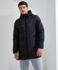 A model wearing a black Microlight Longline Jacket with a hood, paired with grey pants, stands in an indoor setting.