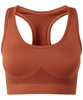 A seamless sports bra in a rich terracotta colour, featuring a mesh back design and a logo.