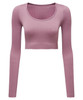 A ribbed seamless crop top in light pink with long sleeves and a round neckline, featuring a logo.