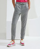 Grey joggers with an elastic waist and cuffs, featuring side pockets, worn with colourful athletic shoes.