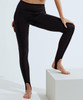 Black recycled fashion stirrup leggings displayed on a model, featuring a sleek design with stirrup details.
