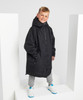 A black waterproof changing robe with a hood, worn by a child standing on a white display.