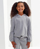 A grey, cropped oversize hoodie displayed on a smiling girl with curly hair, featuring a drawstring at the waist and a logo.