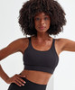 A black sports bra with a crossback design, featuring adjustable straps and a fitted silhouette.